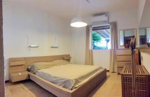 a bedroom with a bed and a window at Sandy Beach Villas 17 in Pyla