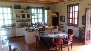 a kitchen with a table with chairs and a kitchen with a tableablish at Ropki Dwór RAJDANY in Ropki