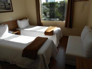 Ein Bett oder Betten in einem Zimmer der Unterkunft Hotel JWF