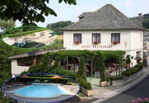 a hotel with a swimming pool in front of a building at Le Florentin in Florentin-la-Capelle