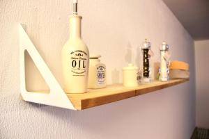 a shelf on a wall with some bottles on it at Ruhige Wohnung in zentraler Lage Tübingens in Tübingen