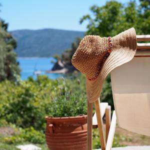 a straw hat sitting on top of a table at Lithea Villas and Studios by the Sea in Aghios Petros Alonissos