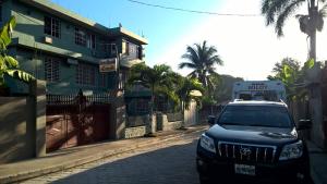 a truck parked on a street next to a building at La Belle Maison Milot in Samson