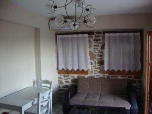 a living room with a couch and a table at Volissos Homes in Volissos +10 photos