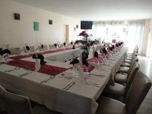 a group of long tables in a room with chairs at L'Ecailler in Ouistreham