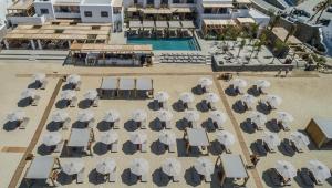 an overhead view of a beach with chairs and umbrellas at Branco Mykonos in Platis Gialos