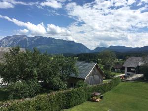 a view of a house with mountains in the background at Gästehaus Lemmerer in Obersdorf