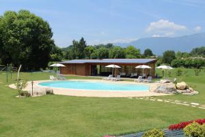a swimming pool in a yard with a building at Country House Barone D'Asolo in Asolo