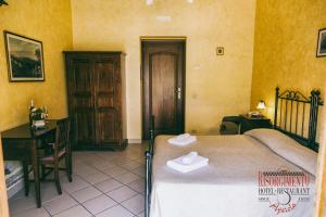 Postel nebo postele na pokoji v ubytování Hotel Risorgimento