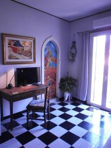 
a living room filled with furniture and a tv at Salvone's house B&B in Giardini Naxos
