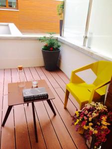 a balcony with a table and a chair and flowers at Piper Cytadela Apartament in Poznań