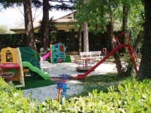 a park with a playground with a slide and a swing at Al Cavallino Bianco in Tricesimo