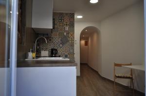 a kitchen with a sink and a counter top at Cativos - Alfama Center District in Lisbon
