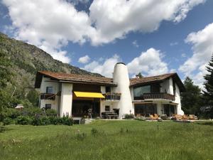a house with a chimney on the side of it at Chesa Suot Ovas in Sils Maria