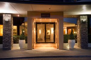 an entrance to a building at night with lights at The George in Christchurch