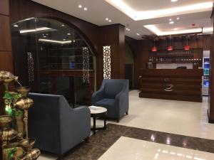 a lobby with two blue chairs and a table at Dar Karim in Abha