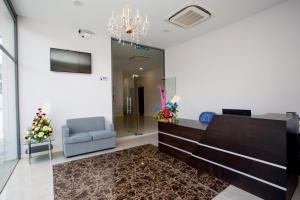 a lobby with a chair and a reception desk at Labuan Fortune Hotel in Labuan