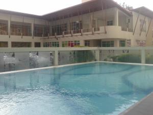 a large swimming pool in front of a building at Migs Place at Tagaytay Prime in Tagaytay