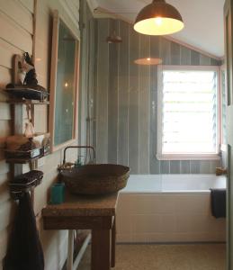 a bathroom with a sink and a bath tub at Birdsong Bellingen Farm in Thora