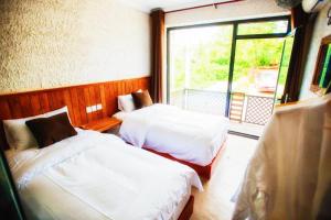 Postel nebo postele na pokoji v ubytování Guixu Huatang Homestay + 37 fotografií