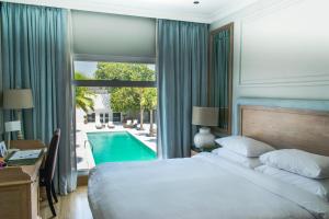 Кровать или кровати в номере Palmyard Hotel
