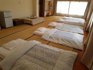 Postel nebo postele na pokoji v ubytování Ryokan Matsukaze