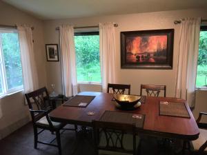 a dining room with a wooden table and chairs at Resurrection River Rentals in Seward
