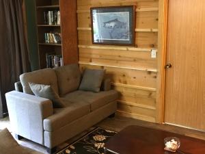 a living room with a couch and a table at Resurrection River Rentals in Seward +51 photos