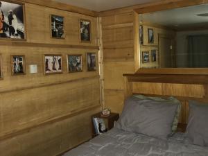 a bedroom with a bed and pictures on the wall at Resurrection River Rentals in Seward