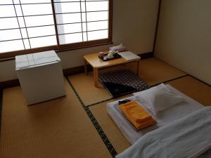 Postel nebo postele na pokoji v ubytování Ryokan Matsukaze