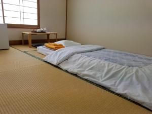 Postel nebo postele na pokoji v ubytování Ryokan Matsukaze
