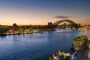 a view of the sydney harbour bridge at night at Pullman Quay Grand Sydney Harbour in Sydney