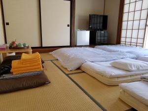 Postel nebo postele na pokoji v ubytování Ryokan Matsukaze + 37 fotografií
