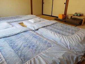 Postel nebo postele na pokoji v ubytování Ryokan Matsukaze