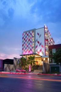 a large building with a colorful facade on a city street at favehotel Sorong in Sorong