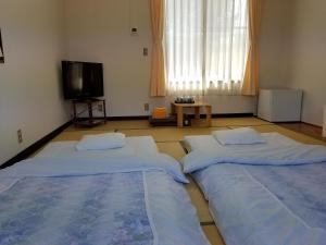Postel nebo postele na pokoji v ubytování Ryokan Matsukaze
