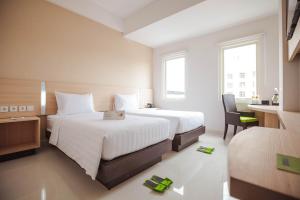 Säng eller sängar i ett rum på Whiz Prime Hotel Sudirman Makassar