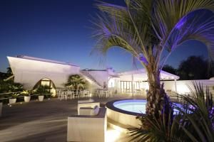 a resort with a swimming pool and a palm tree at Garden Hotel Ripa in Vieste