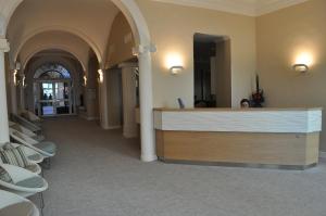 a lobby with a reception desk in a building at Hôtel Vacances Bleues Balmoral in Menton