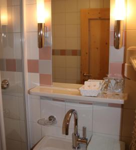 a bathroom with a sink and a mirror at Hotel Schöne Aussicht in Kartitsch