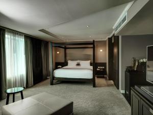 
a hotel room with a bed and a television at S15 Sukhumvit Hotel- SHA Extra Plus in Bangkok
