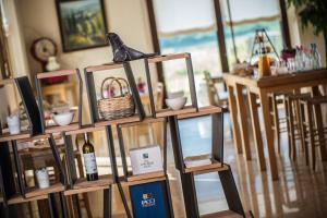 a shelf with a bottle of wine and a basket at Agriturismo La Pertica in Costermano sul Garda