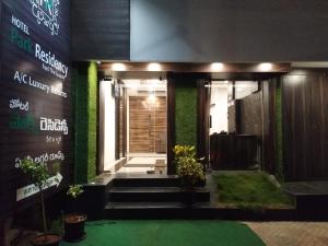 a entrance to a building with green walls and stairs at Hotel Park Residency in Vijayawāda