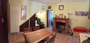 a living room with a chair and a fireplace at Casa Ai Piedi Della Riserva Naturale in Pettorano sul Gizio +14 photos