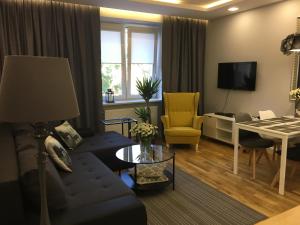 a living room with a blue couch and a table at Family & Business Elegant Apartments KCK ul Astronautów Centrum Downtown - 3 Bedroom, Bath with Hydromassage, Parking in Kielce