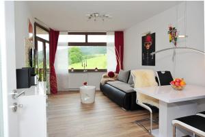 a living room with a couch and a table at Ferienwohnung Bollenhut in Schluchsee