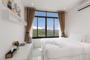 a bedroom with a white bed and a large window at Kamala Regent Residence in Kamala Beach +37 photos