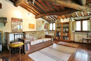a living room with a couch and a book shelf at Apartment Poesia in Bagni di Lucca