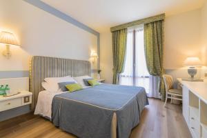 Postel nebo postele na pokoji v ubytování Relais Santa Chiara Hotel - Tuscany Charme