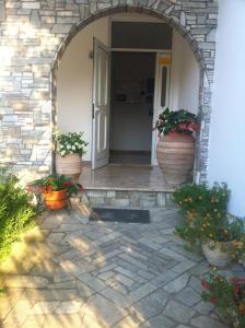 an entrance to a house with two large flower pots at Pefki Villas in Pefki